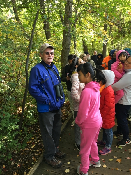 Neil Gore conducts a birding tour of Hall’s Pond