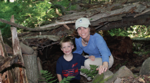 Priscilla Geigis and her nephew Grant pictured in front of their tree fort.