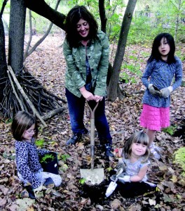 A Brookline family works together to plant native ferns. Photo Credit- Stephanie Springer