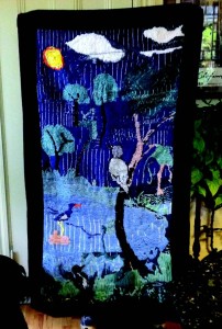 This tapestry was created by Eris' secondgrade class of 1999 at Driscoll School. Two dozen children designed and sewed the tapestry from observations at Hall's Pond in their monthly visits. Key elements are the great blue heron, the sun in the upper left, and a willow tree. Parents and grandparents visiting the classroom collaborated by giving tips on technique. The children and their teacher were honored by Bob Durand, the Secretary of Environmental Affairs, for their activities in environmental education.
